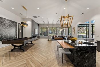 A modern kitchen with a pool table.